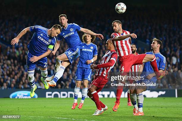John Terry of Chelsea heads clear as he is closed down by Mario Suarez of Club Atletico de Madrid during the UEFA Champions League semi-final second...