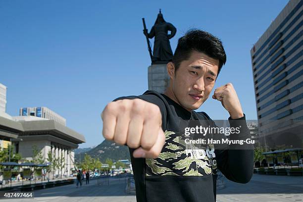 Dong Hyun Kim poses in front of a statue of Admiral Lee Soon-Shin on September 10, 2015 in Seoul, South Korea.