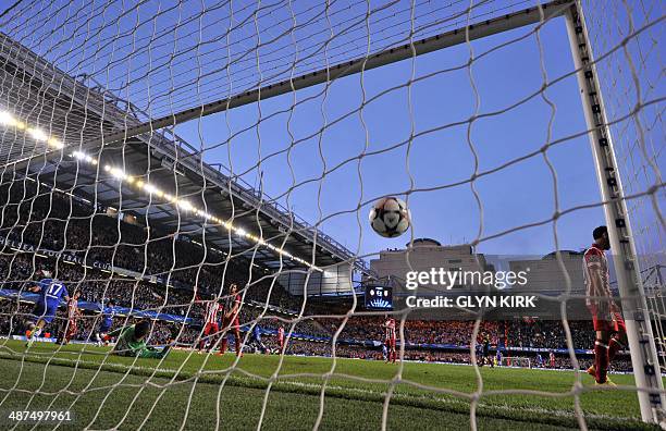 Chelsea's Spanish striker Fernando Torres scores the opening goal past Atletico Madrid's Belgian goalkeeper Thibaut Courtois during the UEFA...