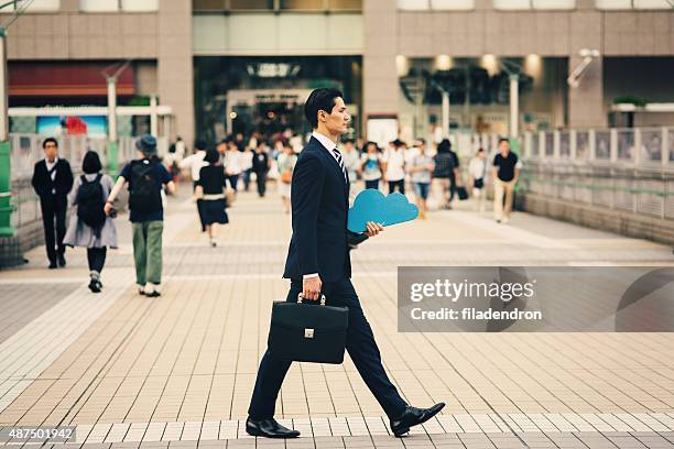 businessman holding cloud computing icon outside - business man walking with a bag in asia bildbanksfoton och bilder