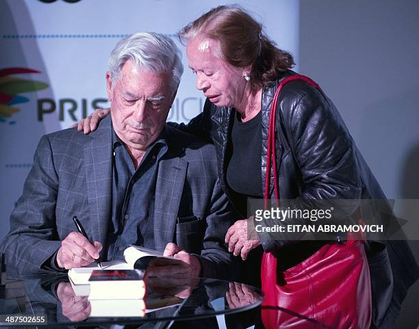 Peruvian 2010 Nobel Prize in Literature laurate Mario Vargas Llosa signs books during the International Book Fair of Bogota, which has Peru as guest...