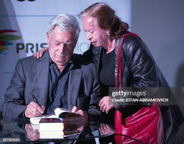 Peruvian 2010 Nobel Prize in Literature laurate Mario Vargas Llosa signs books during the International Book Fair of Bogota, which has Peru as guest...