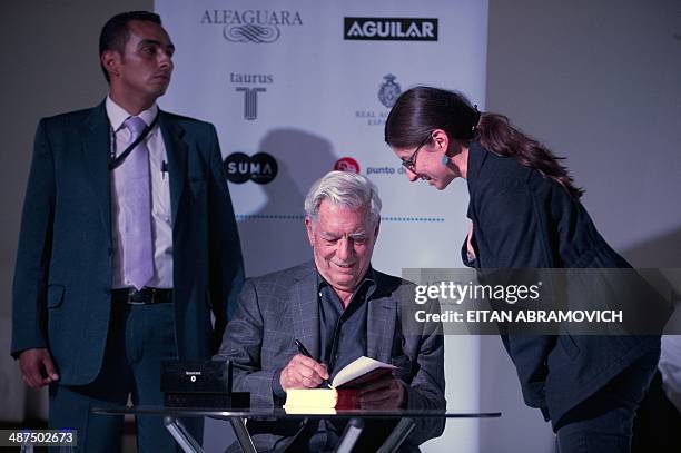 Peruvian 2010 Nobel Prize in Literature laurate Mario Vargas Llosa signs books during the International Book Fair of Bogota, which has Peru as guest...