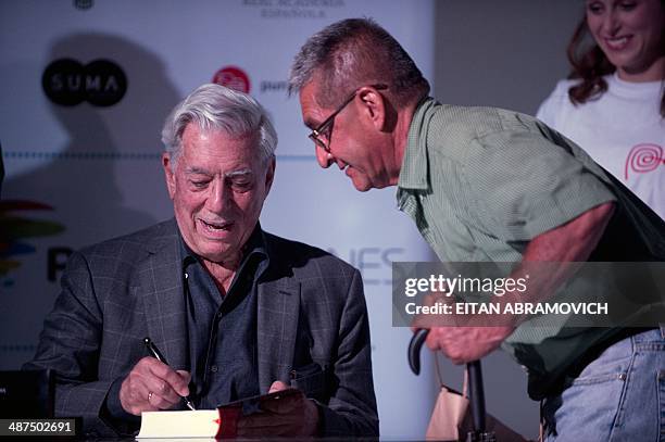 Peruvian 2010 Nobel Prize in Literature laurate Mario Vargas Llosa signs books during the International Book Fair of Bogota, which has Peru as guest...