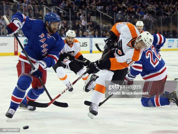 Vincent Lecavalier of the Philadelphia Flyers takes an off balance shot as Dominic Moore of the New York Rangers defends during the first period in...