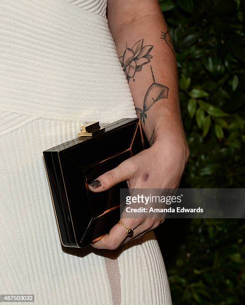 Model Ireland Baldwin, clutch and tattoo detail, arrives at the Salvatore Ferragamo 100 Years In Hollywood celebration at the newly unveiled Rodeo...