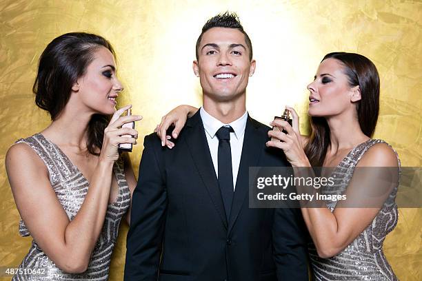 Cristiano Ronaldo poses with models as he unveils his debut fragrence 'Cristiano Ronaldo Legacy' at a launch party on September 9, 2015 in Madrid,...