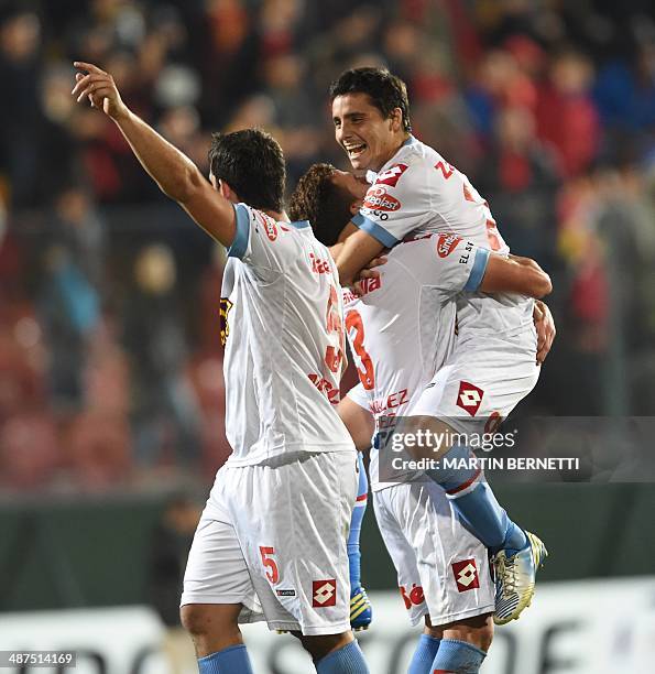 Argentina's Arnenal's players celebrate their victory over Chilean Union Espanola during their Copa Libertadores 2014 round before quarterfinals...