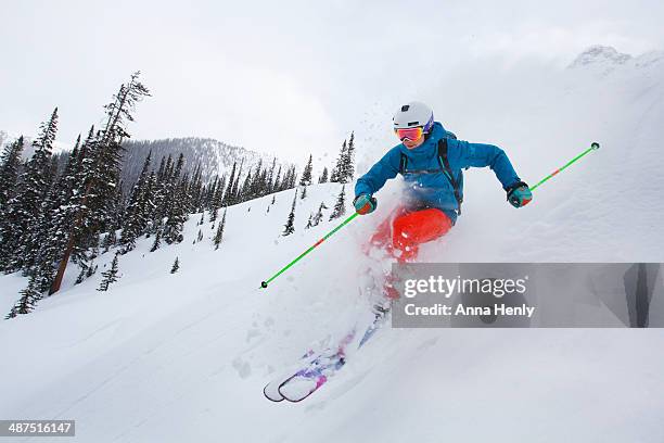 female extreme freestyle skier athlete skis powder - freestyle skiing stock-fotos und bilder