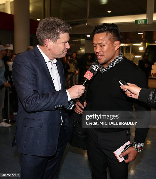 New Zealand All Blacks Keven Mealamu talks to a reporter at the Auckland International Airport in Auckland on September 10, 2015 before departing to...