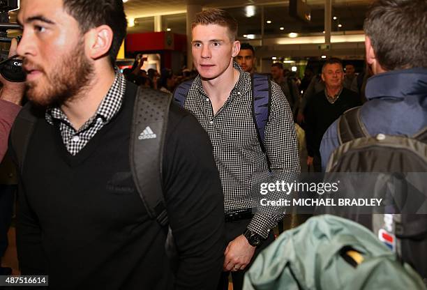 New Zealand All Blacks Nehe Milner-Skudder and Colin Slade arrive at the Auckland International Airport in Auckland on September 10, 2015 before...