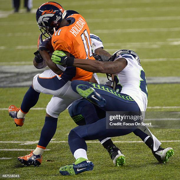 Trindon Holliday returning a kickoff is tackled by Ricardo Lockette of the Seattle Seahawks during Super Bowl XLVIII on February 2, 2014 at MetLife...