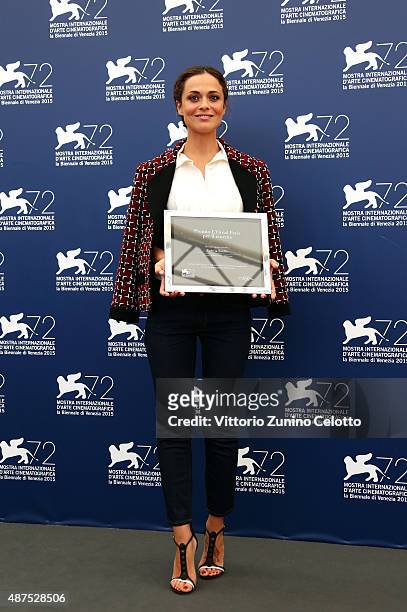 Winner Valeria Bilello poses with her 'L'Oreal Paris per il Cinema' award as she attends the photocall for the L'Oreal Paris Award For Cinema during...