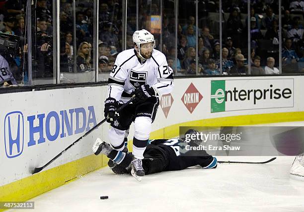 Jarret Stoll of the Los Angeles Kings controls the puck after colliding with Dan Boyle of the San Jose Sharks in Game Seven of the First Round of the...