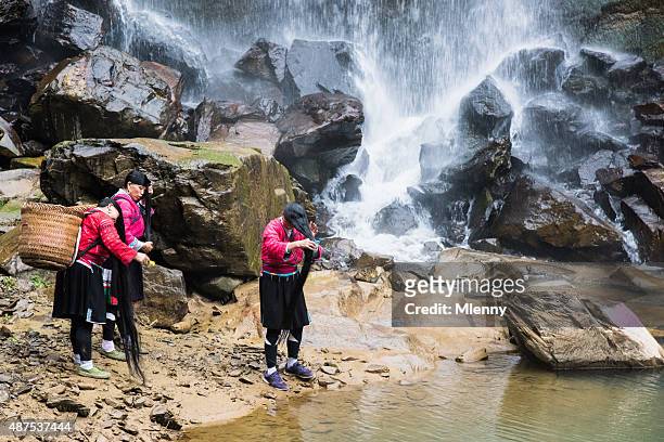 yao tribe women washing long hair at waterfall, longsheng, china - yao tribe stock pictures, royalty-free photos & images