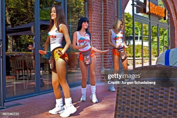 Young female employees outside the Hooters restaurant in the Tiergarten, Berlin, Germany, 2010.