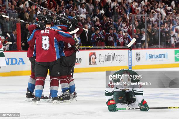 Jan Hejda and other members of the Colorado Avalanche celebrate a goal as Matt Moulson of the Minnesota Wild reacts in Game Seven of the First Round...