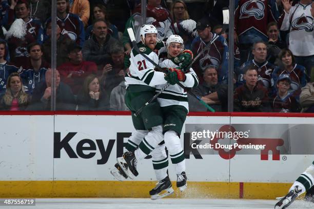 Nino Niederreiter of the Minnesota Wild celebrates his game winning goal with Kyle Brodziak of the Minnesota Wild in overtime against the Colorado...