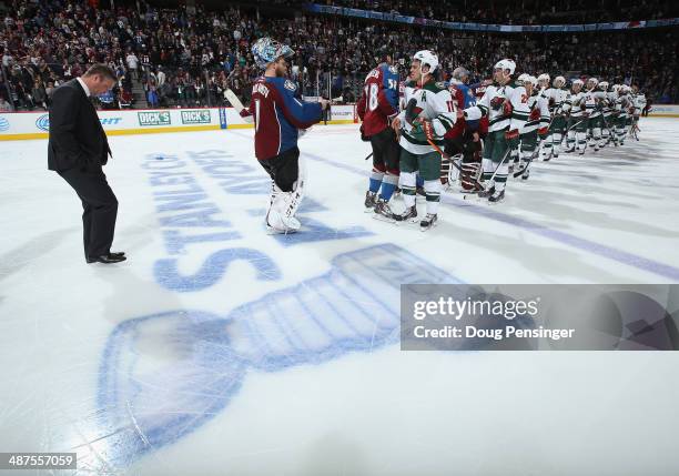 Head coach Patrick Roy of the Colorado Avalanche and goalie Semyon Varlamov of the Colorado Avalanche line up to congratulate Zach Parise and the...