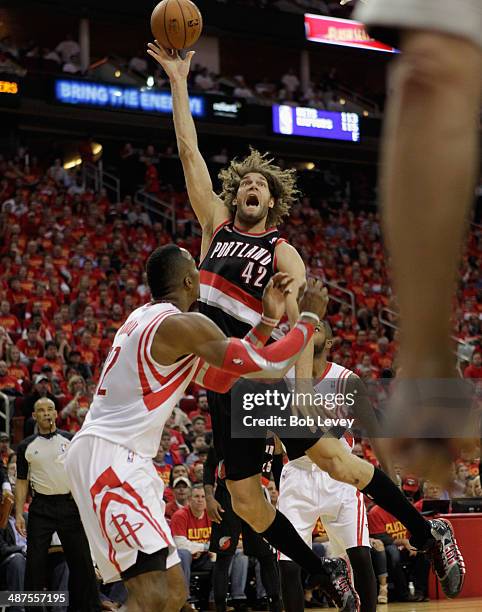 Robin Lopez of the Portland Trail Blazers shoots over Dwight Howard of the Houston Rockets in Game 5 of the Western Conference Quarterfinals during...