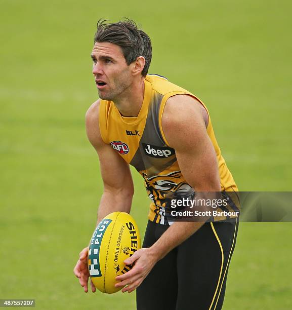 Chris Newman of the Tigers prepares to kick the ball during a Richmond Tigers AFL training session at ME Bank Centre on May 1, 2014 in Melbourne,...