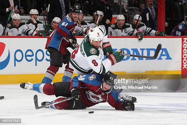 Cody McCormick of the Minnesota Wild falls over Joey Hishon of the Colorado Avalanche in Game Seven of the First Round of the 2014 Stanley Cup...