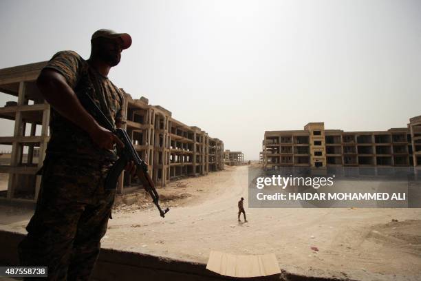 Members of the Popular Mobilisation units hold a position in the Al-Hayakel area on the eastern outskirts of Fallujah during a military operation...