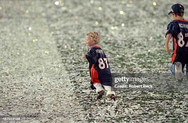 Super Bowl XXXIII: View of Christian McCaffrey and Mac McCaffrey , sons of Denver Broncos Ed McCaffrey, victorious and running on field in their...