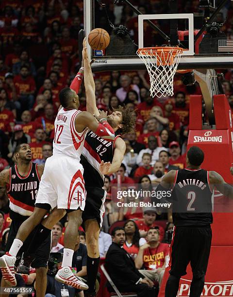 Dwight Howard of the Houston Rockets shoots over Robin Lopez of the Portland Trail Blazers as Wesley Matthews of the Portland Trail Blazers looks for...