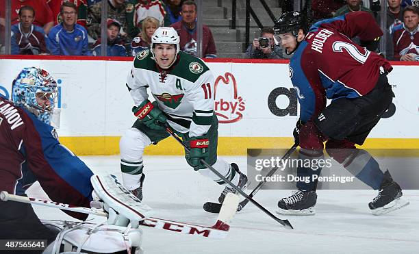Zach Parise of the Minnesota Wild takes a shot against goalie Semyon Varlamov and Nick Holden of the Colorado Avalanche in Game Seven of the First...