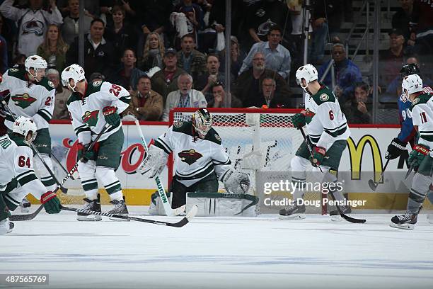 Goalie Darcy Kuemper of the Minnesota Wild defends the goal as Mikael Granlund, Jonas Brodin, Jason Pominville, Marco Scandella and Zach Parise of...