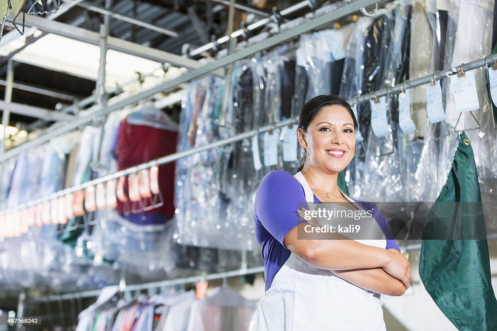 Confident Hispanic woman in her dry cleaning store