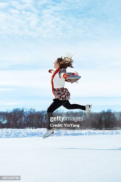 winter skater practising on outdoor ice rink - figure skating girl stock pictures, royalty-free photos & images