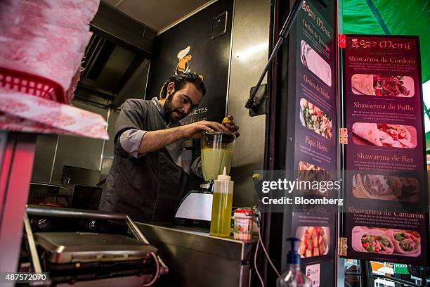 David Barquet, owner and chef of the Camello Gitano Lebanese food truck, prepares a salsa chile at the Street Food Center in a park in the Roma...