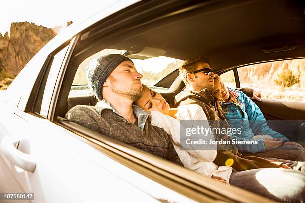 friends passed out in the backseat of a car. - couple sleeping in car stock-fotos und bilder