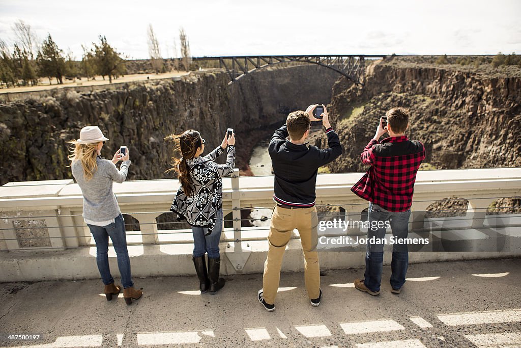 Friends using a cell phone to snap pictures.