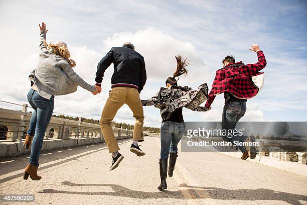friends leaping for fun. - day 4 stock-fotos und bilder