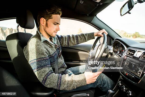 texting and driving. - car interior side stock pictures, royalty-free photos & images