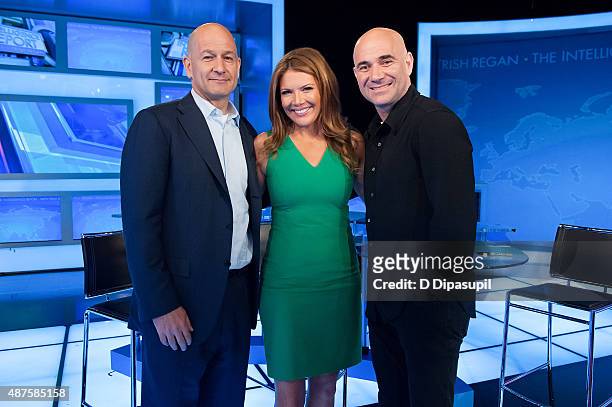 Robert Turner, Trish Regan, and Andre Agassi pose on the set of FOX Business Network at FOX Studios on September 10, 2015 in New York City.