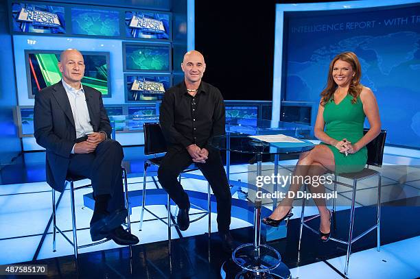 Robert Turner, Trish Regan, and Andre Agassi pose on the set of FOX Business Network at FOX Studios on September 10, 2015 in New York City.