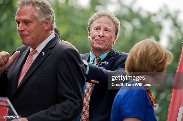 Andy Parker, center, whose daughter Alison, a reporter for WDBJ-TV reporter, was killed on air last month, encourages Gov. Terry McAuliffe, D-Va.,...