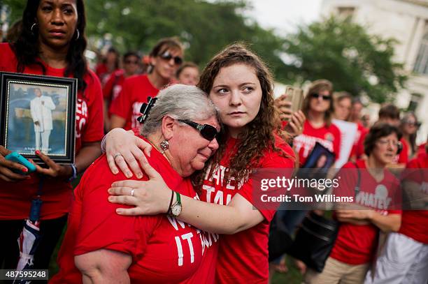 Ashley Cech, right, whose mother Yvonne Cech, a librarian, survived the Sandy Hook shootings, comforts Diane Sellgren, whose daughter Angela...