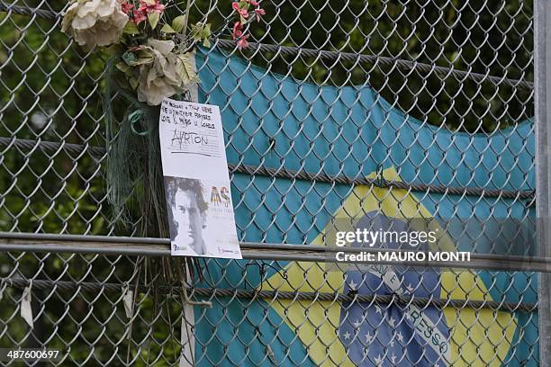 Brazilian flag is hanged on a fence to pay tribute to Brazilian's F1 driver Ayrton Senna during a ceremony to commemorate the 20th anniversary of his...