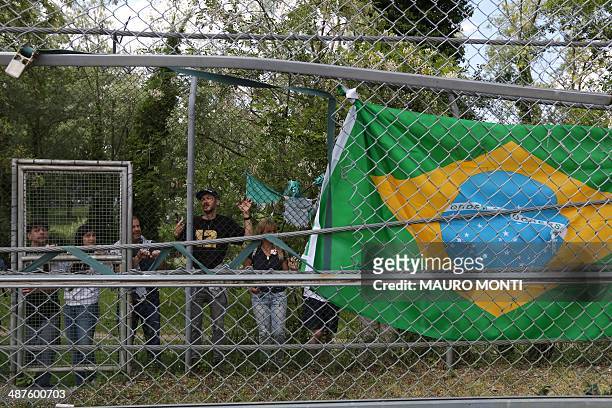 Brazilian flag is hanged on a fence to pay tribute to Brazilian's F1 driver Ayrton Senna during a ceremony to commemorate the 20th anniversary of his...