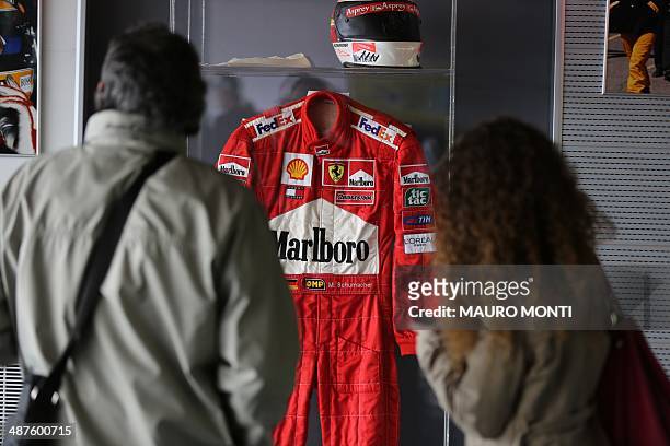 People visit an exhibition which pays tribute to Brazilian's F1 driver Ayrton Senna during a ceremony to commemorate the 20th anniversary of his...