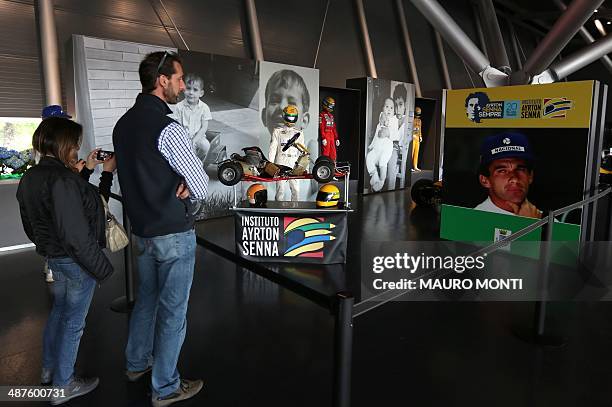 People visit an exhibition which pays tribute to Brazilian's F1 driver Ayrton Senna during a ceremony to commemorate the 20th anniversary of his...