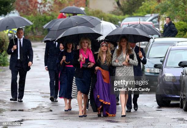 Annabel Elliot, Mark Shand's daughter Ayesha Shand and Katie Elliot arrive at Holy Trinity Church for the funeral of Mark Shand in Stourpaine on May...