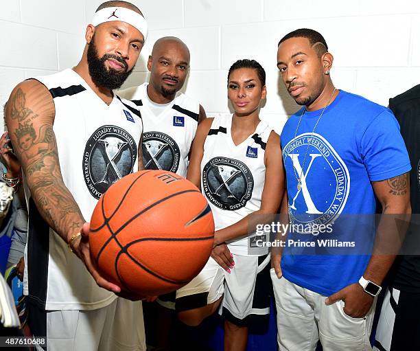 Kenny Burns, Big Tigger, Laura Govan and Ludacris attend Team Luda Vs Team Breezy Celebrity Basketball Game at Georgia State University on September...