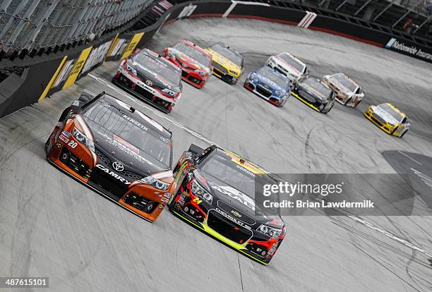 Matt Kenseth, driver of the Home Depot-Husky Toyota, \races with Jeff Gordon, driver of the Axalta Chevrolet, during the NASCAR Sprint Cup Series...