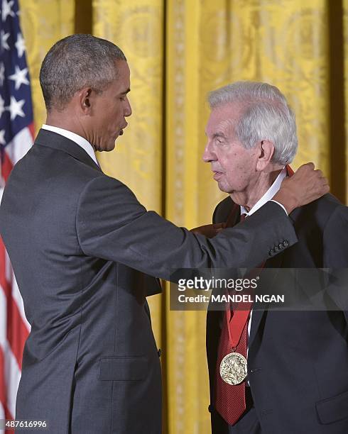 President Barack Obama presents the 2014 National Humanities Medal to writer Larry McMurtry during a ceremony in the East Room of the White House on...